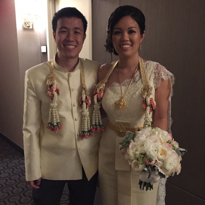 Bride and groom dressed in Thai wedding garb.